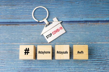 Concept image a wooden block and word - #WFH ( WORK FROM HOME, STAY HOME and STAY SAFE on wooden background. Coronavirus and Covid19 Conceptの写真素材