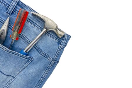 Jeans, screwdriver, hammer and pliers on white background. Jeans texture, Blue denim jeans with...