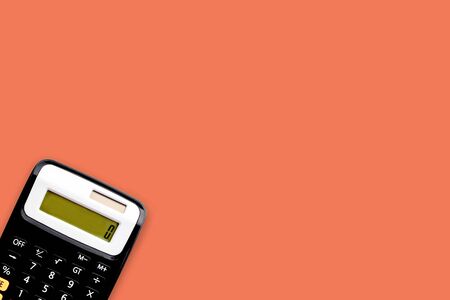 Calculator on orange color background. Business and copy space conceptの写真素材