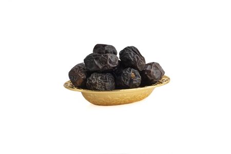 Ajwa Dates fruits or dry dates isolated on white background.Ramadan Kareem Breaking the fast by eating Tamar Datesの写真素材