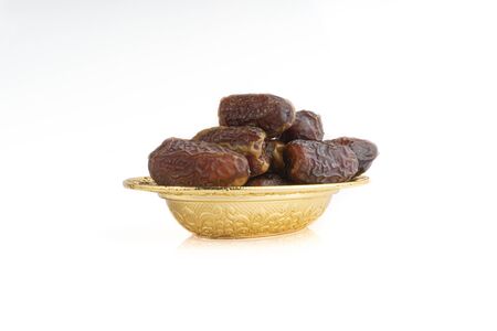 Date fruits or dry dates isolated on white background.Ramadan Kareem Breaking the fast by eating Tamar Datesの写真素材