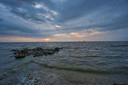 Peaceful beach view and waves during sunset at Jeram, Kuala Selangor Malaysiaの写真素材