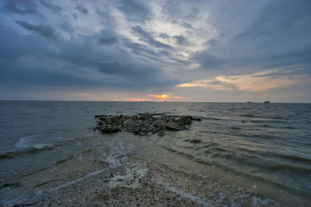 Peaceful beach view and waves during sunset at Jeram, Kuala Selangor Malaysiaの写真素材