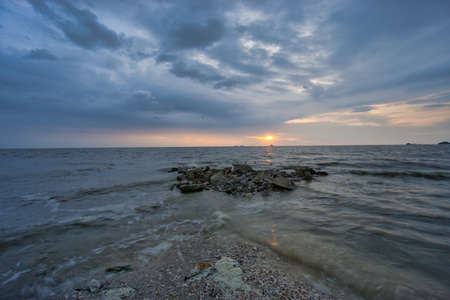 Peaceful beach view and waves during sunset at Jeram, Kuala Selangor Malaysiaの写真素材
