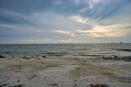 Peaceful beach view and waves during sunset at Jeram, Kuala Selangor Malaysiaの写真素材