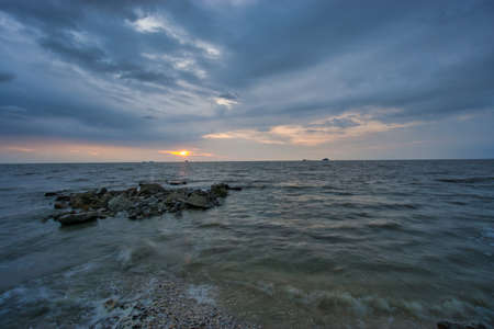 Peaceful beach view and waves during sunset at Jeram, Kuala Selangor Malaysiaの写真素材