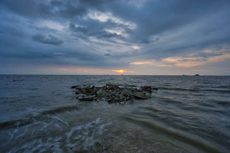 Peaceful beach view and waves during sunset at Jeram, Kuala Selangor Malaysiaの写真素材