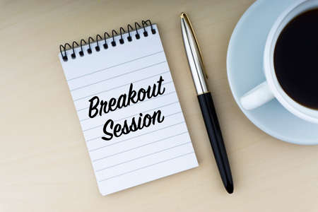 BREAKOUT SESSION text with fountain pen and cup of coffee on wooden background. Business and copy space concept.の写真素材