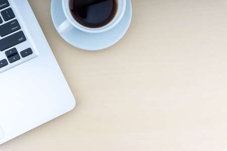 Laptop and cup of coffee on wooden background. Business and copy space concept.の写真素材