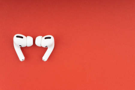 Kuala Lumpur, Malaysia - December 1,2020 : AirPods Pro on red background