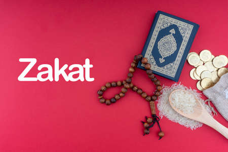 ZAKAT words with Holy Quran, Coins, Rosary and Rice. Zakat concept. Zakat is a form of alm-giving as a religious obligationの写真素材