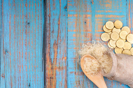 Coins and Rice. Zakat concept. Zakat is a form of alm-giving as a religious obligationの写真素材