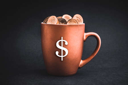 DOLLAR MONEY  sign text with Coins in cups on black background. Tax, Savings, Profit and Investment Conceptの写真素材