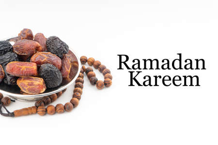 RAMADAN KAREEM text with Dates or kurma fruits and rosary beads or Tasbih on white background. Ramadan Kareem and Islamic Conceptの写真素材