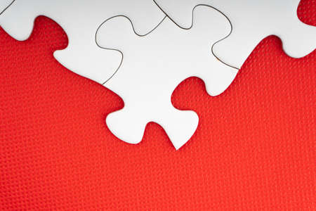 Red jigsaw puzzle pieces on red background. Copy space and business conceptの写真素材