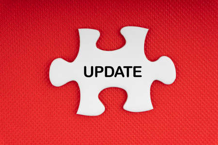 UPDATE text with jigsaw puzzle on red background. Business and Motivation Conceptの写真素材
