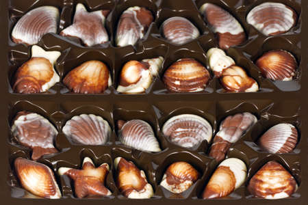 Assorted chocolates in the form of a seashell in a box. の写真素材