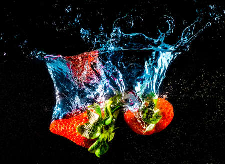 Strawberry falling into the waterの写真素材