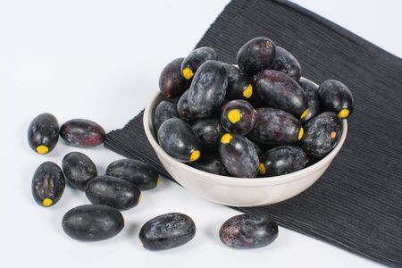 Dabai Fruit or Canarium odontophyllum in a bowl over white backgroundの写真素材