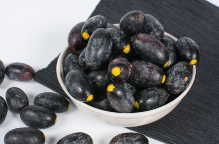 Dabai Fruit or Canarium odontophyllum in a bowl over white backgroundの写真素材