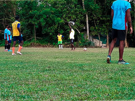 The boys are playing foot balls on the playground. Sports is a medium of physical exercise, foot ball is one of them.  State of West Bengal in India,village of briddhapalla, 17July 2020, 5:28pm.のeditorial素材