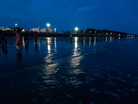 Very beautiful water waves and lighting of Digha sea of India after sunset. White clouds in the blue sky.の写真素材