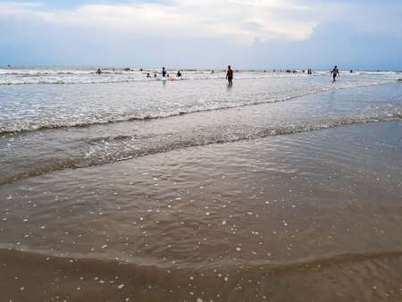 The beauty of India's long sea at sunset. Black clouds in the blue sky and the reflection of red sunlight.の写真素材