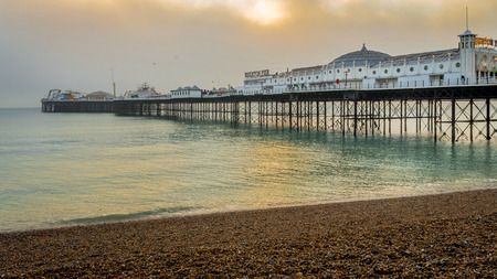 Brighton, Sussex, United Kingdom - 30 Dec, 2016 : A view of the Brighton Pier on a lovely winter evening just before sunset from the pebble beachのeditorial素材