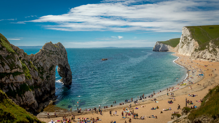 Durdle Door, Jurassic Coast, Dorset, West Lulworth, United Kingdom - 16th July, 2016. Sunbathers enjoying the warm sunshine on a weekend at Durdle Doorのeditorial素材
