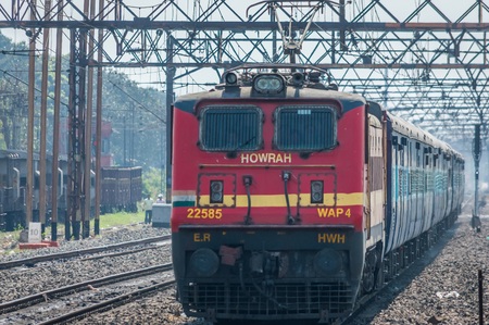 Kolkata, India - 4 March 2018: Express train pulled by an electric locomotive Engine traveling towards Howrah station after an overnight journey, Kolkata, West Bengal, Indiaのeditorial素材