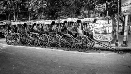 KOLKATA, WEST BENGAL / INDIA - DECEMBER 3, 2019: Traditional hand pulled indian rickshaw on the...