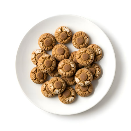 White plate filled with 17 small brown sugar cookies, each topped with brown sugar, soft lighting, detailed, cinematic, warm.の写真素材