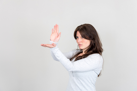 Studio shot of young woman gesturing with her handsの写真素材