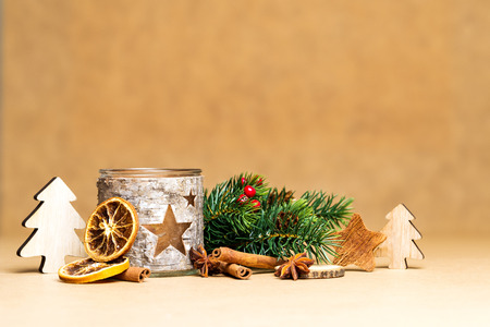 Christmas decoration and carved tea-light holder with stars in front of brown background as templateの写真素材