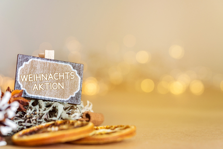 Christmas decoration with xmas deal sign in german and warm festive bokeh lights in background as templateの写真素材