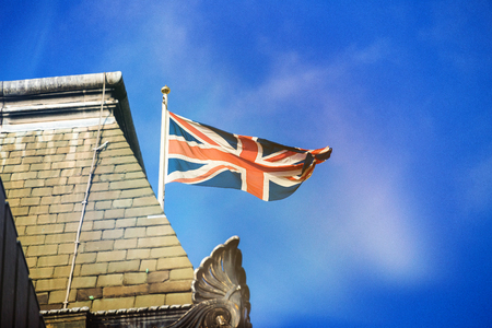 Union Jack at building against blue sky in London United Kingdomのeditorial素材