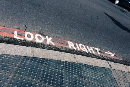 Look right hint painted on asphalted road as safety warning in London, United Kingdomの写真素材