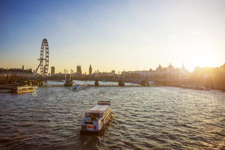 Cityscape of London with London big giant wheel, River Thames and Houses of Parliament with Big Ben at sunsetのeditorial素材