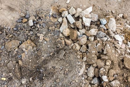 Close-up of untidy construction ground soil with pebbles and clay from aboveの写真素材