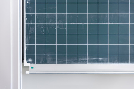 Detail of empty blue blackboard with free copy space for text or image messages with checked pattern as backgroundの写真素材