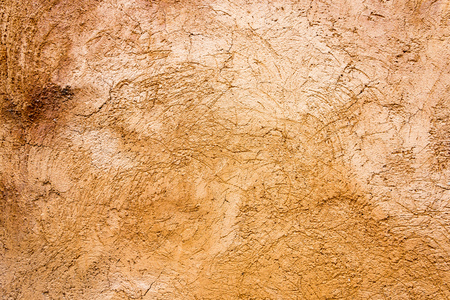Weathered old worn brown plaster with joints for wall or floor with texture as backgroundの写真素材