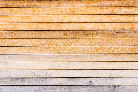 Weathered old worn wooden textured planks for wall or floor in brown with rusty nails as backgroundの写真素材