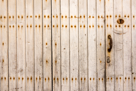 Weathered old worn wooden textured planks for wall or floor in brown with rusty nails as backgroundの写真素材