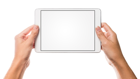 Blank empty white tablet screen with hands holding the device up with isolated white space in the backgroundの写真素材