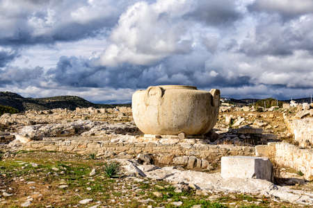 Massive stone vase in Amathus ruins, Cyprus under stormy cloudsの写真素材