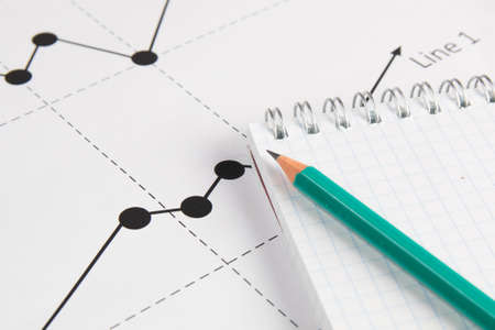 Business drawing graphics, pancil and white notepadの写真素材