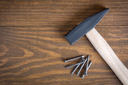 Hammer and nails on a wooden backgroundの写真素材