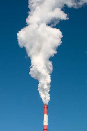 Industrial, ecology and environmental protection. Smoke from the chimney of the industrial plant.