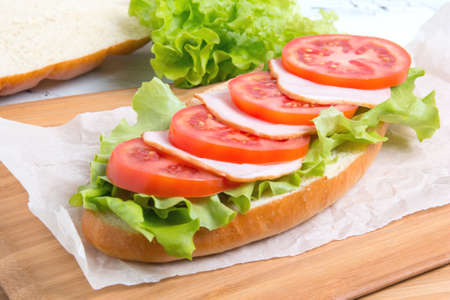 baguette sandwich with ham, tomatoes and lettucの写真素材