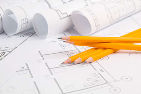Pencils and paper with engineering house drawings and blueprints.の写真素材
